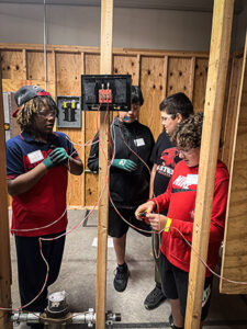 Students practice wiring a doorbell at the IBEW Local 110 training center. 