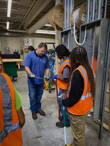 Photo: Tim Garcia instructs MTA interns at IBEW 110. 